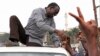 Ugandan opposition party leader Kizza Besigye shakes hands with supporters before being arrested on September 4, 2012 in Kampala.