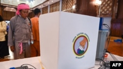 FILE - An observer looks at a voting machine that is to be used in future elections, in Yangon, Malaysia, on Sept. 5, 2023. Myanmar's junta chief said the warring country would hold an election in December 2025 or January 2026, the first since the military staged a coup in 2021.