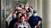 FILE - Job seekers line up outside a Career Center in Frankfort, Kentucky, June 18, 2020. 
