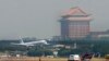 FILE - With the landmark Grand Hotel in rear, a plane carrying the first wave of mainland China tourists from the coastal city of Xiamen lands at the Taipei Airport, Friday, July 4, 2008, in Taipei, Taiwan.