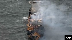 Asap mengepul dari kontainer yang rusak di dek kapal kargo MV Solong di Laut Utara, di lepas pantai Withernsea, sebelah timur Inggris, 11 Maret 2025, setelah bertabrakan dengan kapal tanker MV Stena Immaculate pada 10 Maret. (Paul ELLIS / AFP)