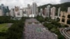 FILE - Tens of thousands of residents gather to march in downtown streets during an annual pro-democracy protest in Hong Kong Tuesday, July 1, 2014. 