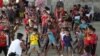FILE - Children who traveled with their families from Venezuela play at the shelter in Arauquita, Colombia, March 25, 2021, on the border with Venezuela.