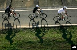 FILE - Cyclists cruise down a bike path in Taipei, Taiwan. Taipei is now examining ways to improve traffic safety for riders.