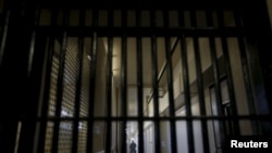 A guard stands behind bars at the Adjustment Center during a media tour of California's Death Row at San Quentin State Prison in San Quentin, California December 29, 2015. America's most populous state, which has not carried out an execution in a decade, 