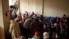 FILE - Syrians waiting for their appointments at the U.N. refugee agency's registration center in Zahleh, in Lebanon's Bekaa Valley. 