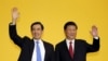 Chinese President Xi Jinping and Taiwan's President Ma Ying-jeou, left, wave to the media during a summit in Singapore, Nov. 7, 2015. 