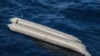A rubber boat is seen after having capsized with more than 100 migrants on board, during a search and rescue operation in the Mediterranean Sea, off the Libyan Coast, April 22, 2021.