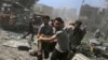 FILE - Men transport a casualty after what activists said were airstrikes by forces loyal to Syria's President Bashar al-Assad on a busy marketplace in Douma, near Damascus, Syria, Aug. 12, 2015. 