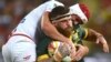 FILE - England's Chris Hill tackles Australia's Josh Mcguire during а match of the Rugby League World Cup, in Land Park, Brisbane, Australia, Dec. 2, 2017.