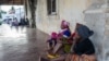 People wait on the outskirts of the seaport of Pemba on March 30, 2021 for the possible arrival of their families evacuated from the coasts of Afungi and Palma after the attack by armed forces against the city of Palma on March 24, 2021.