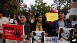 Indians holds placards during a protest against a new citizenship law out side Gandhi Ashram in Ahmadabad, India, Tuesday, Dec. 17, 2019.