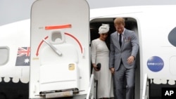 Britain's Prince Harry and Meghan, Duchess of Sussex disembark from their plane on their arrival in Suva, Fiji, Oct. 23, 2018.