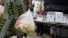 FILE - Seona Ngufor of Cameroon carries bags of squash.