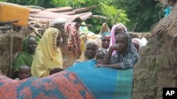 wadansu mata da yara suna tsaye a kofar gida