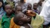 FILE - A health official administers a polio vaccine to children at a camp in Maiduguri, Nigeria, Aug. 28, 2016. 