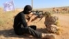 FILE - A rebel fighter from the "First Battalion" under the Free Syrian Army takes part in a military training in the rebel-held countryside of the northern city of Aleppo, June 10, 2015.