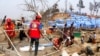 FILE - Authorities and volunteers from aid agencies rebuild shelters for Rohingya refugees who lost their dwellings to a fire at Balukhali camp at Ukhiya in Cox's Bazar district, Bangladesh, March 24, 2021. 