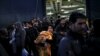 Refugees and migrants arrive aboard the passenger ferry Nissos Rodos at the port of Piraeus, near Athens, Greece, Jan. 13, 2016.
