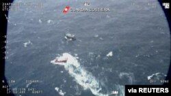 A fishing boat carrying migrants is seen from Italian coast guard helicopter during a search and rescue operation in Mediterranean sea on Apr. 24, 2021, in this screen grab obtained by Reuters on Apr. 25, 2021. (Italian Coast Guard/Handout via Reuters)