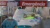 Health workers treat a COVID-19 patient at the emergency unit of a field hospital set up to treat COVID patients in Ribeirao Pires, greater Sao Paulo area, Brazil, April 13, 2021.