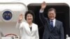 South Korean President Moon Jae-in and his wife, Kim Jung-sook, wave before leaving for the United States at the Seoul military airport in Seongnam, South Korea, June 28, 2017. Moon left for the United States for a summit meeting with his U.S. counterpart