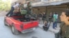 FILE - Free Syrian Army fighters inspect a pick-up truck with a weapon installed on it as they gather during what they said was an operation to travel to the northern countryside of Aleppo to fight Islamic State fighters, in Aleppo, Syria.