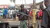A body is seen at the site of a bomb explosion at a road in Kaduna, Nigeria, April 8, 2012.