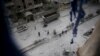People inspect the damage at a site hit with airstrikes by pro-Syrian government forces in the rebel held Douma neighborhood of Damascus, Syria, Feb. 14, 2016.