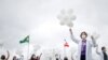 Nurses hold balloons during a protest asking for COVID-19 vaccines, in Brasilia, Brazil, April 7, 2021.