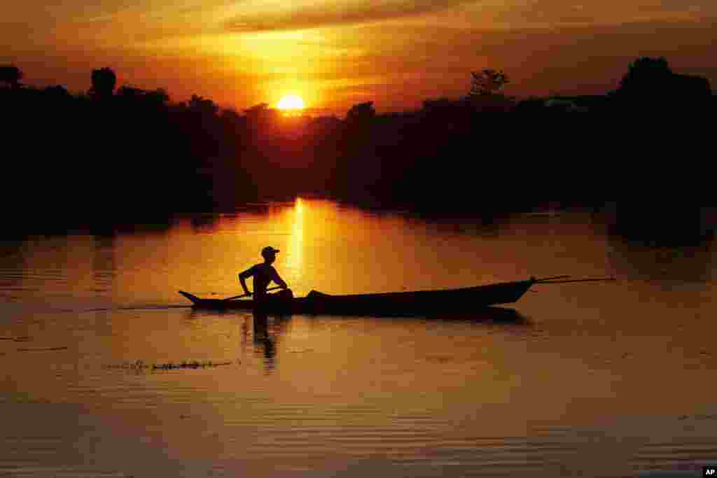 A fisherman paddles his boat on a lake during the sunset in Naypyitaw, Myanmar.