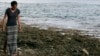 FILE - Poet and global warming activist Kathy Jetnil-Kijiner walks along the shore at low tide in Majuro Atoll in the Marshall Islands, Nov. 8, 2015.