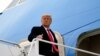 FILE - President Donald Trump gestures as he boards Air Force One upon arrival at Valley International Airport, in Harlingen, Texas, Jan. 12, 2021.