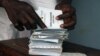 A man searches for his voting card at a polling unit in Cameroon's capital Yaounde, (File photo).