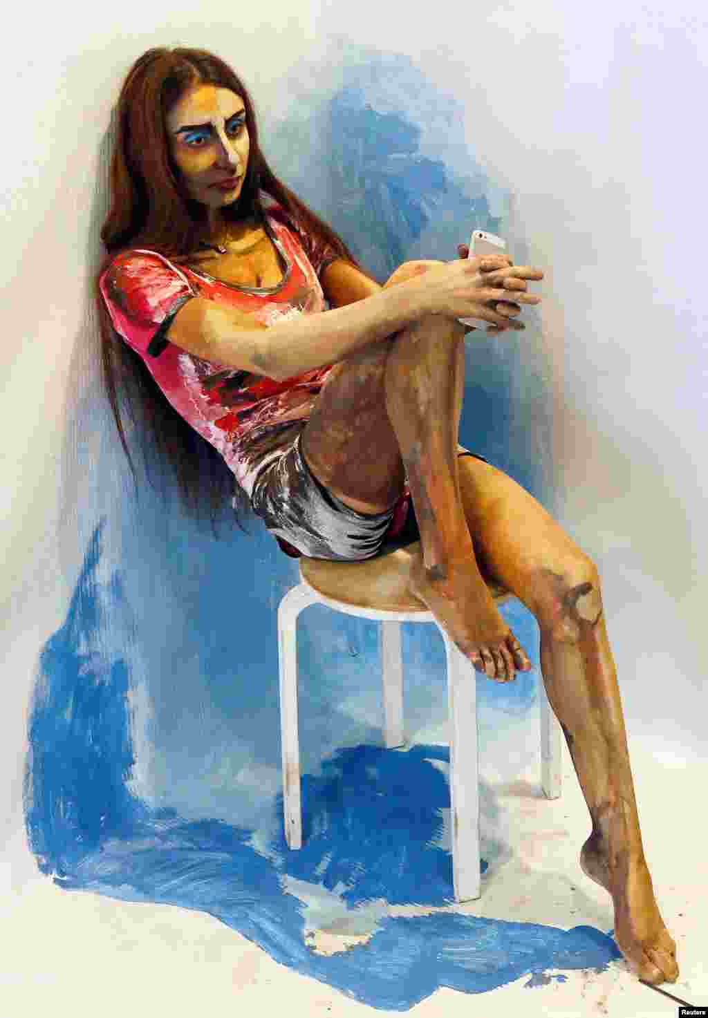 Model Inna Magomedova presents "The Alive Painting" body art work by Russian artist Maria Gasanova during the Art Krasnoyarsk annual festival in Siberian city of Krasnoyarsk, Russia.