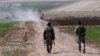 FILE - Turkish soldiers patrol near the border with Syria, ouside the village of Elbeyli, east of the town of Kilis, southeastern Turkey, July 24, 2015.