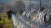 Slovenian soldiers erect a razor-wired fence on the Croatian border in Gibina, Slovenia, Nov. 11, 2015. The government aims to prevent the uncontrolled entry of more migrants in the already-overwhelmed alpine state. 